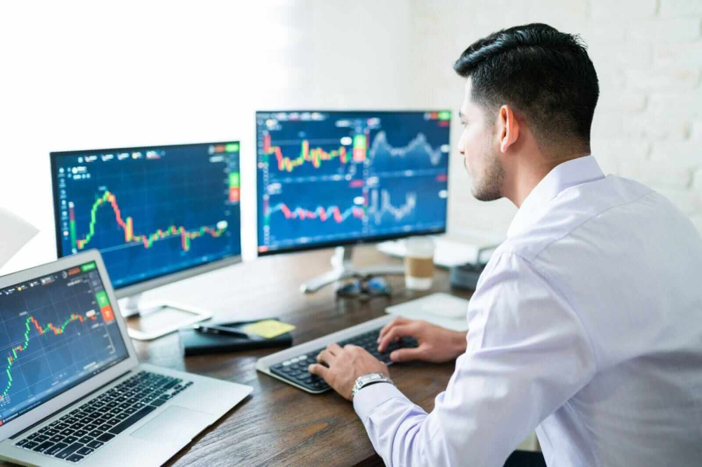 Stock trader looking at charts by Antonio Diaz via iStock